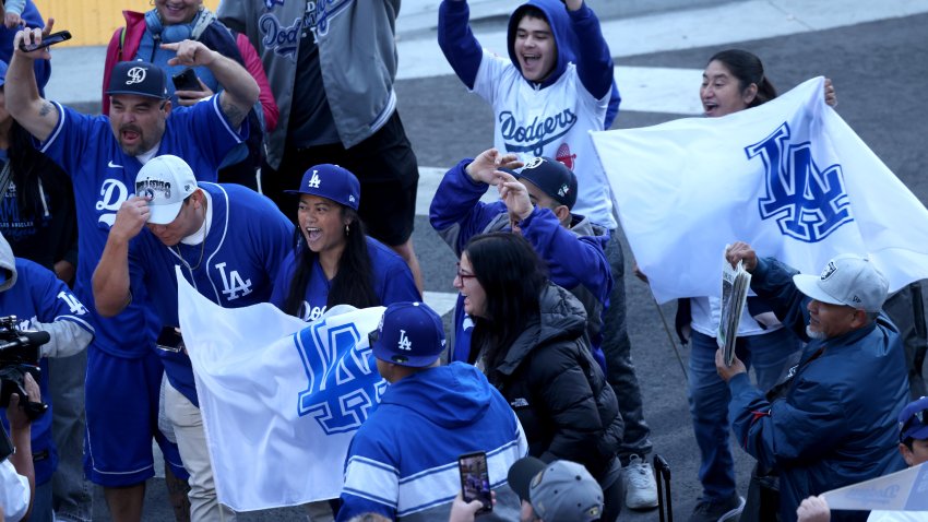 LOS ANGELES, CA – NOVEMBER 1, 2024 – – Fans get into the spirit in the early morning, hours before the Los Angeles Dodgers celebrate their World Series win traveling in a parade route along 5th Street in downtown Los Angeles on November 1, 2024. (Genaro Molina/Los Angeles Times via Getty Images)