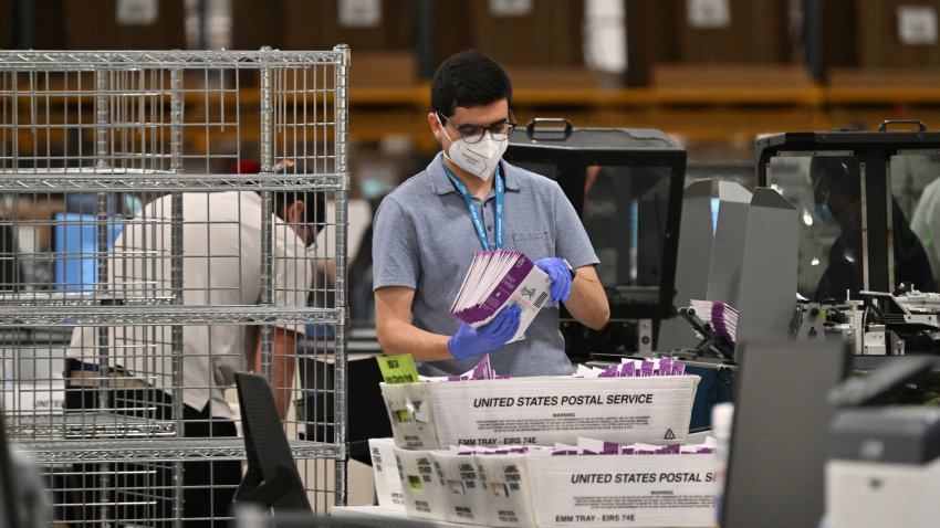 Mail-in ballots are prepared for signature verification at the Los Angeles County Ballot Processing Center on the eve of Election Day, November 4, 2024, in City of Industry, California. (Photo by Robyn Beck / AFP) (Photo by ROBYN BECK/AFP via Getty Images)