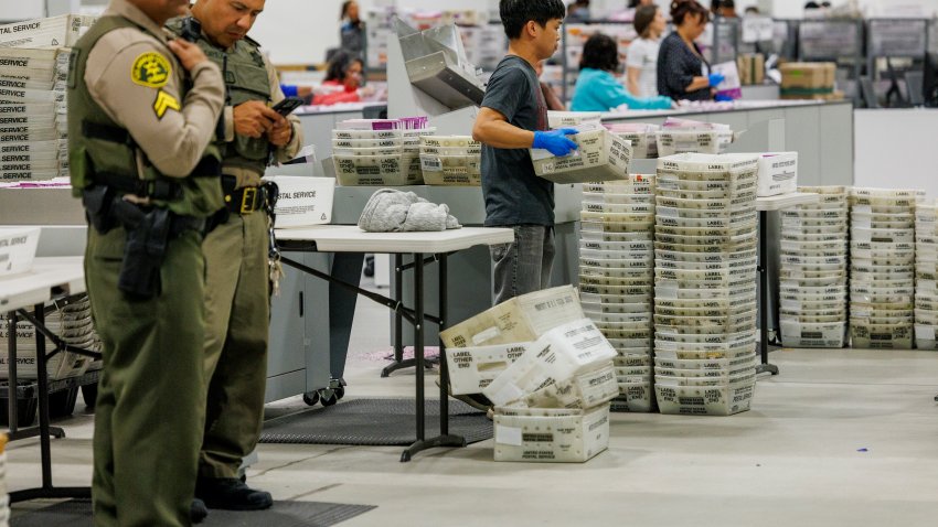 CITY OF INDUSTRY, CA – NOVEMBER 5, 2024: LA County Sheriff Deputies stand guard as election workers handle ballots at the Los Angeles County Ballot Processing Center on November 5, 2024 in the City of Industry, California. (Gina Ferazzi / Los Angeles Times via Getty Images)