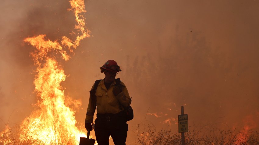 MOORPARK, CALIFORNIA – NOVEMBER 07: A firefighter works as the Mountain Fire burns on November 7, 2024 near Moorpark, California. Fueled by strong winds, the fire has burned across more than 20,000 acres and destroyed over 50 homes since it began yesterday. (Photo by Mario Tama/Getty Images)