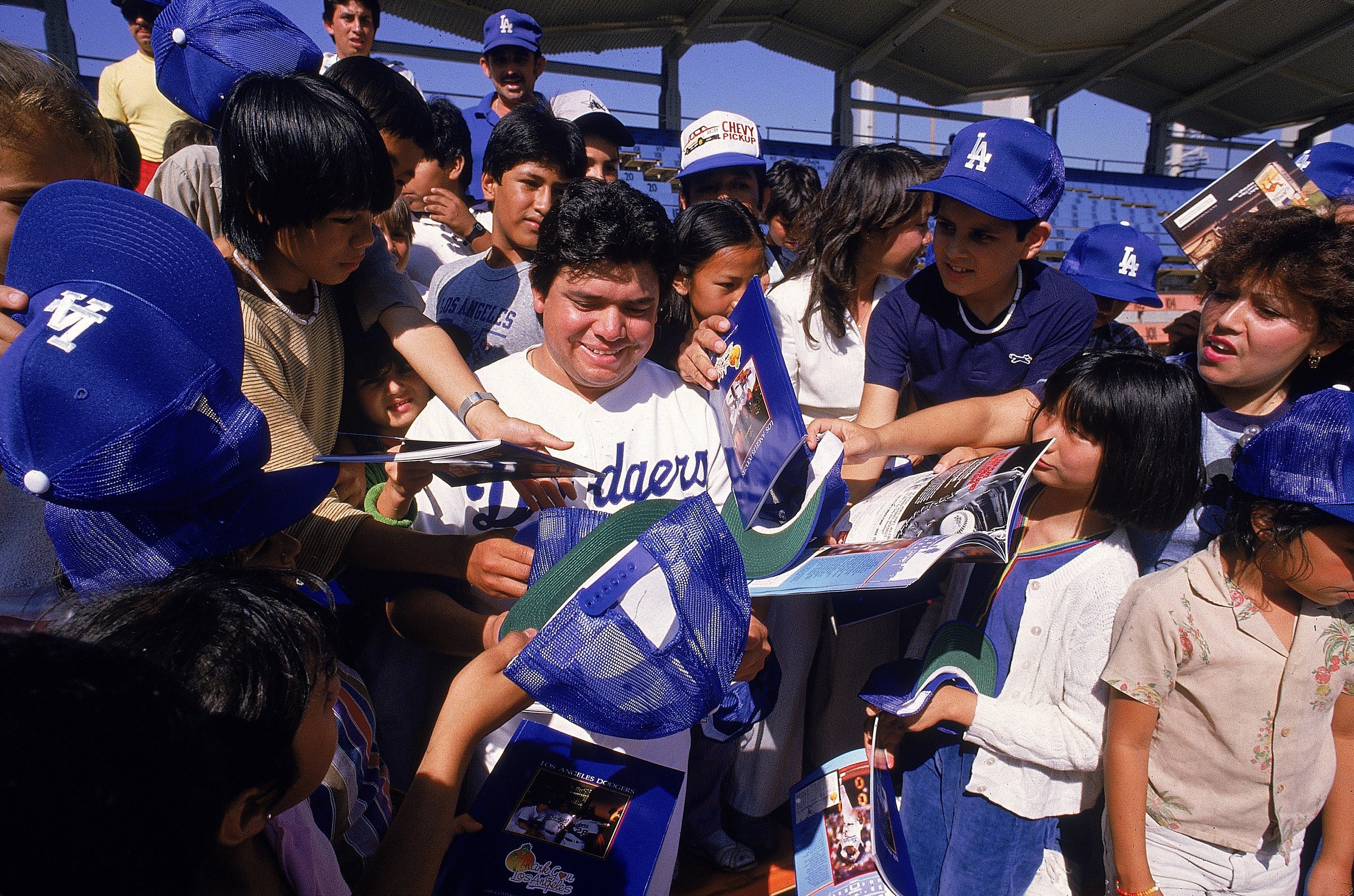 UNITED STATES – JUNE 17:  Baseball: Los Angeles Dodgers Fernando Valenzuela signing autographs and surrounded by fans before game, Los Angeles, CA 6/17/1985  (Photo by Richard Mackson/Sports Illustrated via Getty Images)  (SetNumber: X31631)