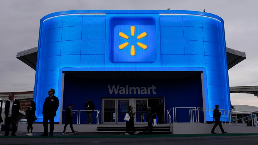 FILE - People walk by the Walmart booth during the CES tech show on Jan. 9, 2024, in Las Vegas.