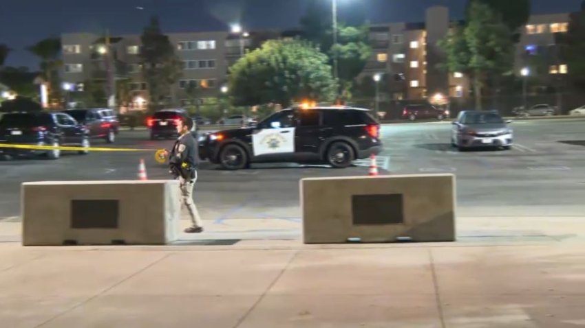 An officer places police tape at BMO Stadium in Exposition Park Friday Nov. 22, 2024.