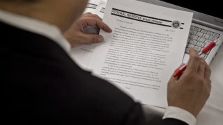 A member of the media views a Federal Reserve press release ahead of a news conference following a Federal Open Market Committee (FOMC) meeting in Washington, D.C., U.S., on Wednesday, June 14, 2017.