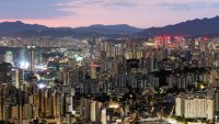 Commercial and residential buildings are illuminated at dawn in Seoul, South Korea, on Saturday, Oct. 21, 2023. South Korea has prepared a financial support program of 75.9 trillion won ($56.97 billion) for companies increasing investment in key sectors as well as small businesses struggling with the impact of high interest rates.