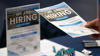 A jobseeker takes a flyer at a job fair at Brunswick Community College in Bolivia, North Carolina, on April 11, 2024.