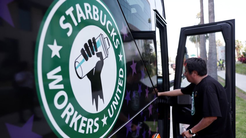 A Starbucks worker boards the Starbucks union bus after Starbucks workers stood on the picket line with striking SAG-AFTRA and Writers Guild of America members in solidarity outside Netflix studios in Los Angeles on July 28, 2023.