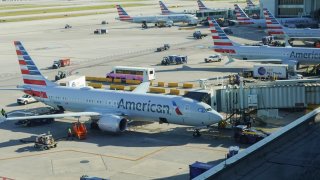 American Airlines planes sit by their gates at the Miami International Airport on October 25, 2024 in Miami, Florida.