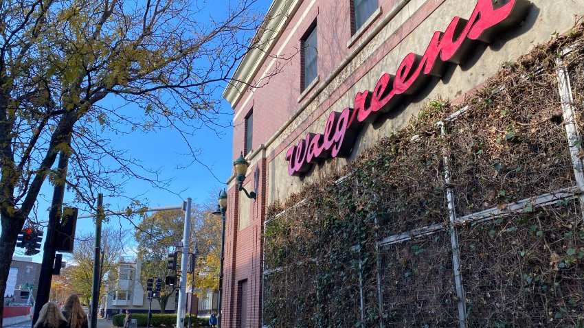 People walk by a Walgreens on November 3, 2024 in Brookline, Massachusetts.