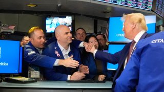 President-elect Donald Trump is greeted by traders as he walks the floor of the New York Stock Exchange on Dec. 12, 2024.