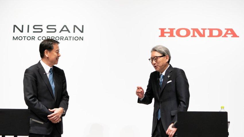 Nissan Motor CEO Makoto Uchida (L) listens to Honda Motor CEO Toshihiro Mibe (R) attend a joint press conference on March 15, 2024 in Tokyo, Japan. 