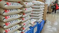 Bags of rice sit stacked high in a supermarket in central Tokyo on November 22, 2024.