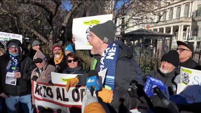 Demonstrators rally outside City Hall as Mayor Eric Adams meets with Trump border czar