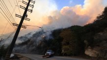 A mountainside burns as the Franklin Fire grows in Malibu, California, on December 10, 2024. A wind-fanned wildfire quickly spread early on Tuesday in Malibu, threatening homes and businesses in the coastal California community where many Hollywood elites reside. (Photo by DAVID SWANSON / AFP) (Photo by DAVID SWANSON/AFP via Getty Images)