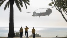 MALIBU, CA - DECEMBER 10: An Orange County fire helicopter lifts off after picking up water from a pond at Pepperdine University while fighting the Franklin fire in Malibu, CA on Tuesday, Dec. 10, 2024. (Myung J. Chun / Los Angeles Times via Getty Images)