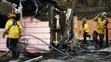 MALIBU, CALIFORNIA - DECEMBER 10: Firefighters work at a home burned in the Franklin Fire on December 10, 2024 in Malibu, California. The wildfire has scorched 2,200 acres near Pepperdine University prompting evacuations along the coast amid high winds with some homes destroyed. (Photo by Mario Tama/Getty Images)