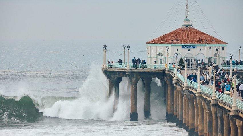 Manhattan Beach, CA - December 22:A winter swell builds up, with huge waves crashing on the shore. Manhattan Beach Pier on Sunday, Dec. 22, 2024 in Manhattan Beach, CA. (Marcus Ubungen / Los Angeles Times via Getty Images)