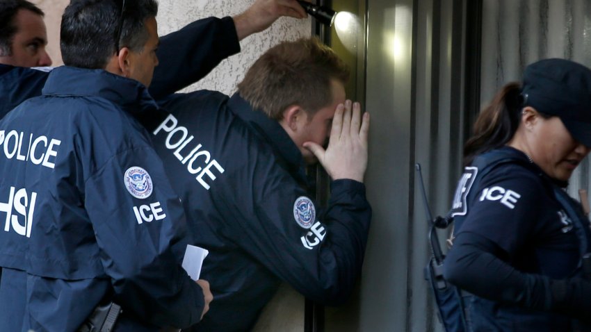 ROWLAND HEIGHTS, CA. – MARCH 3: Immigration and Customs Enforcement (ICE) agents from the Department of Homeland Security look into the window of an apartment while executing search warrants during an ongoing investigation of alleged birth tourism centers on March 3, 2015 in Rowland Heights, California. Agents from multiple federal and local law enforcement agencies executed search warrants in Orange, Los Angeles and San Bernardino counties on Tuesday morning.