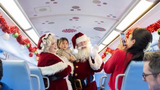 Santa and Mrs. Claus greet visitors aboard Metrolink's Holiday Express Train in this promotional photo.