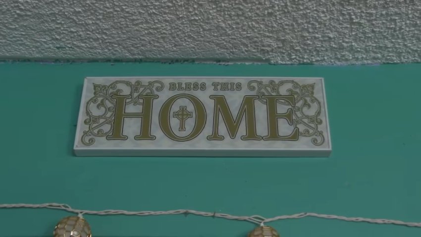 A plaque about home rests in Eagle Rock resident Sally Juarez's home, as seen on Wednesday, Dec. 14, 2024.