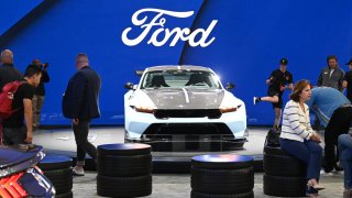 Attendees visit the Ford display during the AutoMobility LA 2024 auto show at the Los Angeles Convention Center on Nov. 21, 2024.