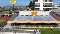 In an aerial view, customers enter a Denny’s restaurant on February 13, 2023 in Emeryville, California. 