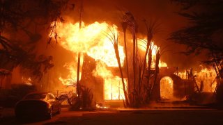 Fire engulfs a home as the Eaton Fire moves through the area on Jan. 8, 2025, in Altadena, California. 