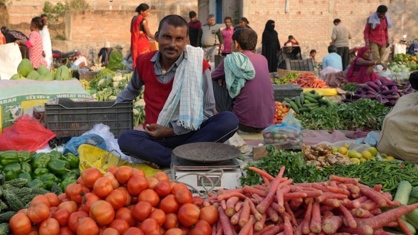 A man stands at his makeshift vegetable shop at a temporary open-air market in Samastipur, Bihar, India, on november 29, 2024.(Photo by Bilal Kuchay/NurPhoto via Getty Images)