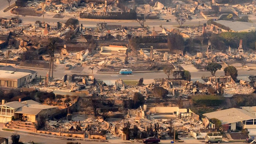 In this aerial view taken from a helicopter, burned homes are seen from above during the Palisades fire near the Pacific Palisades neighborhood of Los Angeles, California on January 9, 2025. 