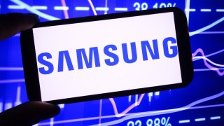 Photo illustration showing the Samsung Group company logo displayed on a smartphone screen.