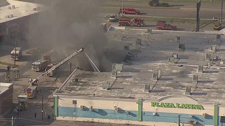 Dallas firefighters battle a fire at Plaza Latina on Friday, Jan. 3, 2025.