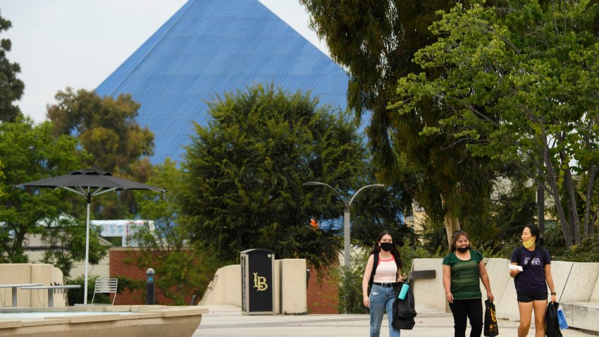 People walk on the California State University Long Beach (CSULB) campus. (Photo by Patrick T. FALLON / AFP) (Photo by PATRICK T. FALLON/AFP via Getty Images)