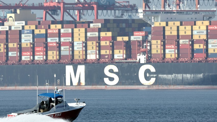 LONG BEACH, CALIFORNIA – DECEMBER 04: A Long Beach Fire Department boat passes shipping containers stacked on a container ship at the Port of Long Beach on December 4, 2024 in Long Beach, California. U.S. President-elect Donald Trump is threatening new tariffs on multiple countries as his second term approaches after making tariffs a signature of his 2024 Presidential campaign. The ports of Los Angeles and neighboring Long Beach is the country’s busiest container port complex. (Photo by Mario Tama/Getty Images)