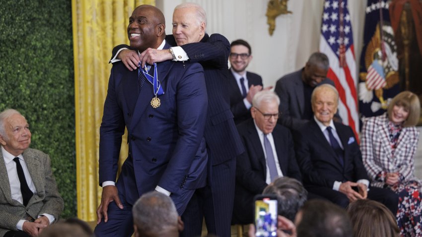 WASHINGTON, DC – JANUARY 4: Former NBA player Earvin “Magic” Johnson crouches while being awarded the Presidential Medal of Freedom by U.S. President Joe Biden in the East Room of the White House on January 4, 2025 in Washington, DC. President Biden is awarding 19 recipients with the nation’s highest civilian honor. (Photo by Tom Brenner/Getty Images)