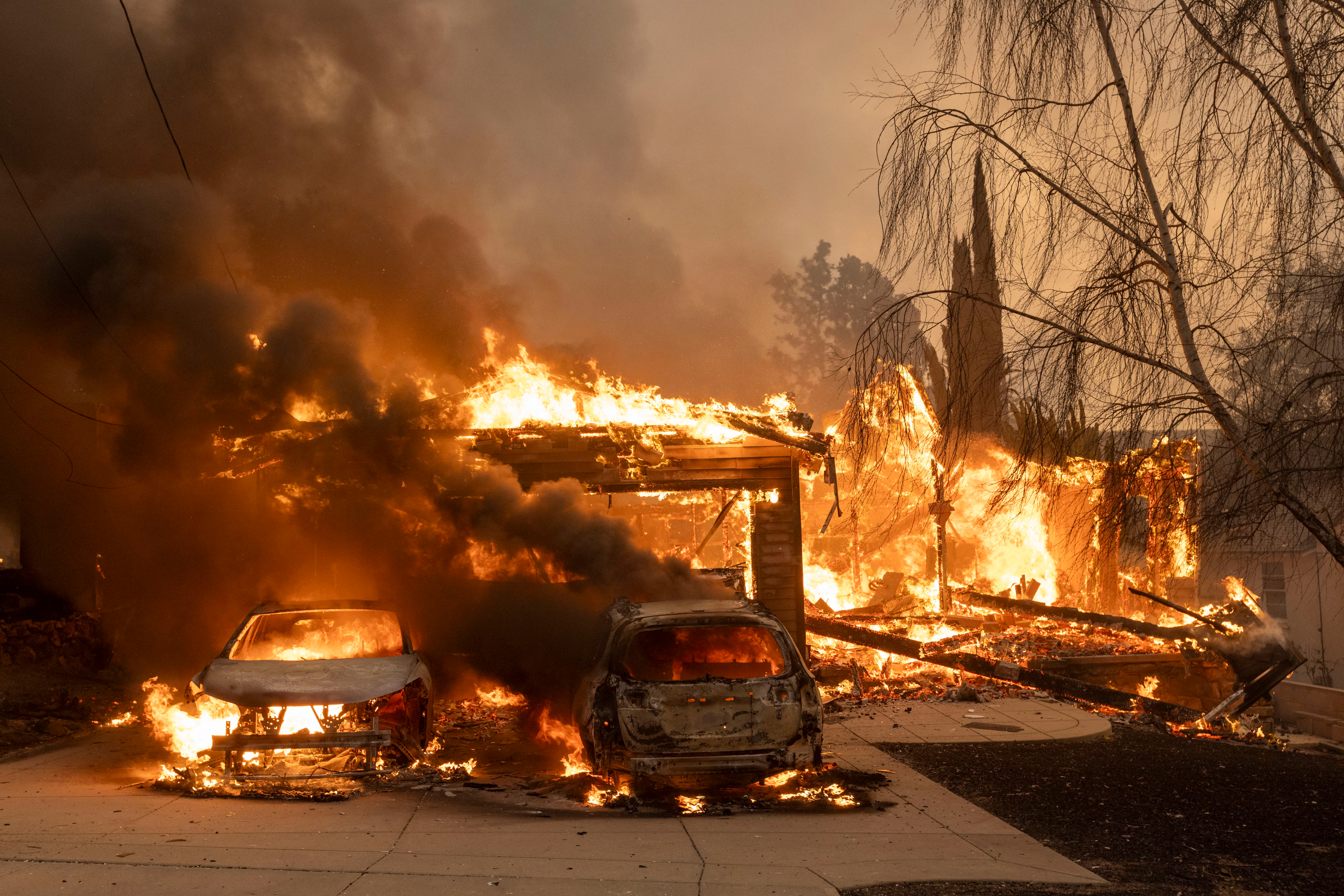 Vehicles burn during the Eaton Fire in Altadena on Wednesday, Jan. 8, 2025.