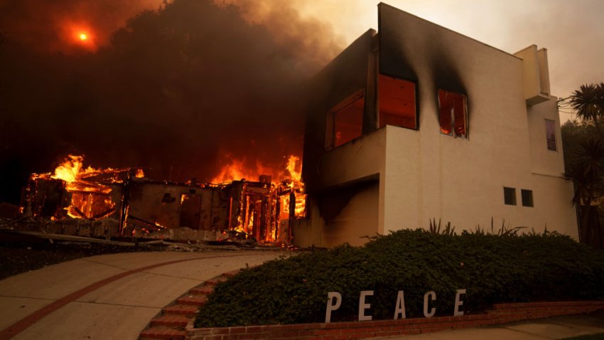 Flames from the Palisades Fire burn a home on January 8, 2025 in the Pacific Palisades neighborhood of Los Angeles, California.