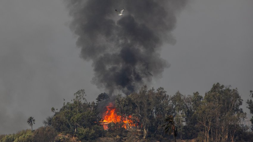 LOS ANGELES, CALIFORNIA – JANUARY 9: Flames from the Palisades Fire burns a home amid a powerful windstormon January 9, 2025 in the Pacific Palisades neighborhood of Los Angeles, California. Multiple wildfires fueled by intense Santa Ana Winds are burning across Los Angeles County. At least five people have been killed, and over 25,000 acres have burned. Over 2,000 structures have also burned and almost 180,000 people are under orders to evacuate.  (Photo by Apu Gomes/Getty Images)