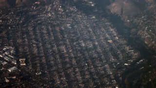 This aerial photo shows homes and businesses reduced to smoldering rubble by the Palisades Fire in the Pacific Palisades neighborhood of Los Angeles