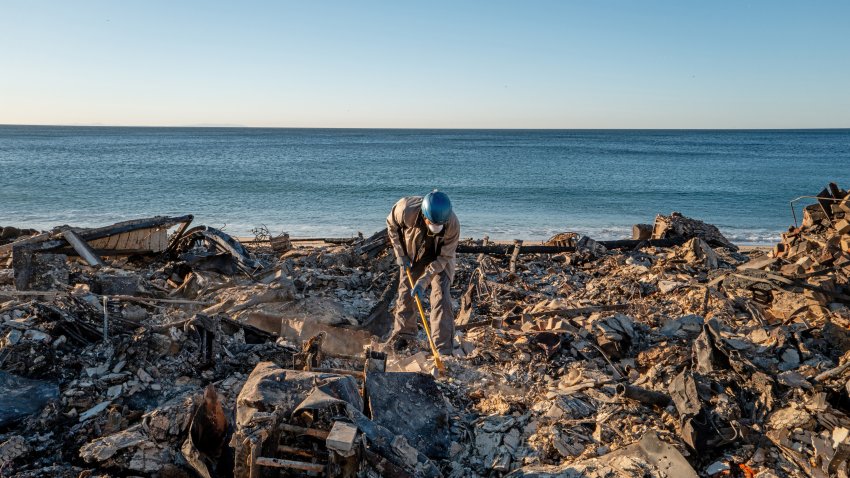 Patrick O'Neal sifts through his home after it was destroyed by the Palisades wildfire