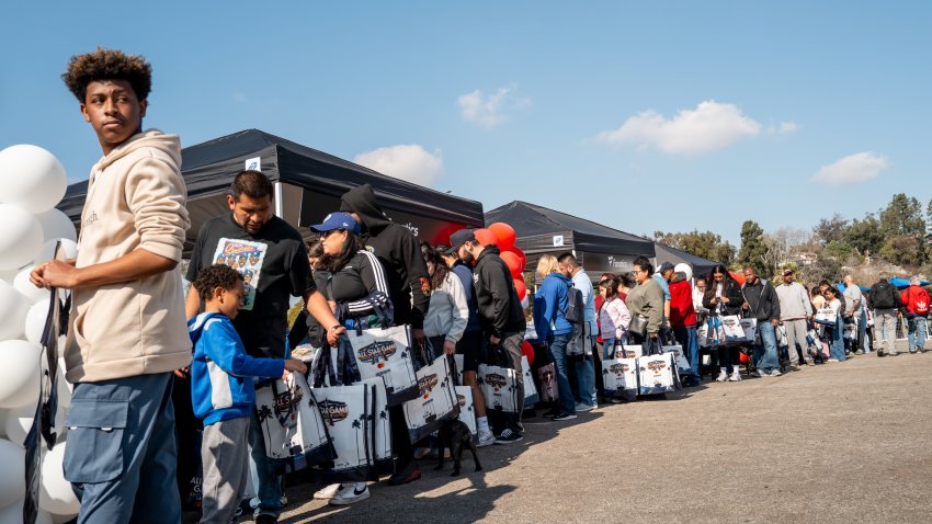 LOS ANGELES, CALIFORNIA – JANUARY 17: People affected by the LA wildfires stand in line to receive aid and resources during an essentials distribution event at Dodger Stadium on January 17, 2025 in Los Angeles, California. Multiple wildfires fueled by intense Santa Ana Winds are burning across Los Angeles County. Reportedly at least 10 people have died with over 180,000 people having been under evacuation orders. Over 9,000 structures have been damaged or burned while more than more than 25,000 acres were burning from the fires. (Photo by Brandon Bell/Getty Images)