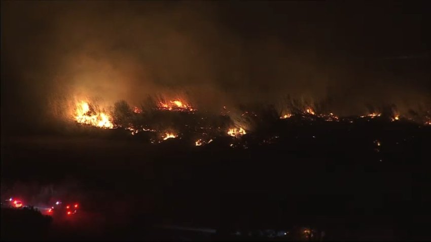Firefighters in Ventura battle a brush fire, dubbed the Auto Fire, on Monday, Jan. 13, 2025.