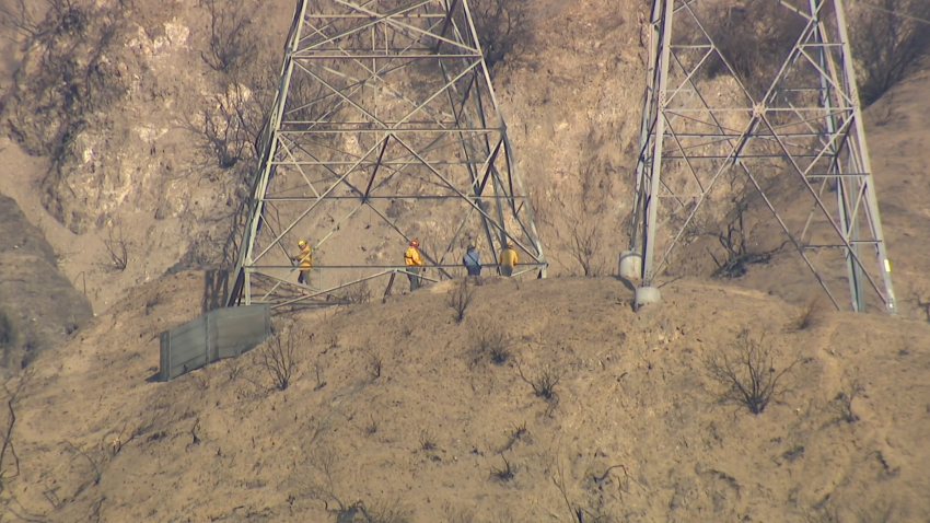 FILE IMAGE shows investigators examining the area under the M16T1 tower above Altadena, close to where the Eaton Fire started on January 7, 2025.