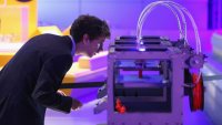 A technician checks on a 3D printer as it constructs a model human figure in the exhibition ‘3D: printing the future’ in the Science Museum on October 8, 2013 in London, England.