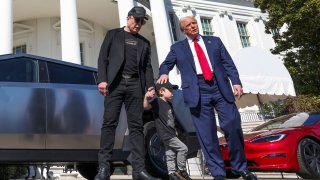 U.S. President Donald Trump talks to the media, next to Tesla CEO Elon Musk with his son X Æ A-12, at the White House in Washington, D.C., U.S., March 11, 2025.