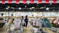 Customers browse children’s clothing at a wholesale store in Chongqing, China, on March 1, 2025.