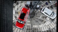 A Volkswagen (VW) Passat R car (L) and a Golf GTI car are pictured in the tower storage facility of German carmaker Volkswagen at the company’s headquarters in Wolfsburg, central Germany, on March 11, 2025.