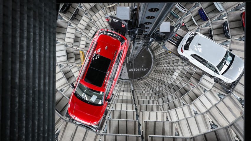 A Volkswagen (VW) Passat R car (L) and a Golf GTI car are pictured in the tower storage facility of German carmaker Volkswagen at the company’s headquarters in Wolfsburg, central Germany, on March 11, 2025.