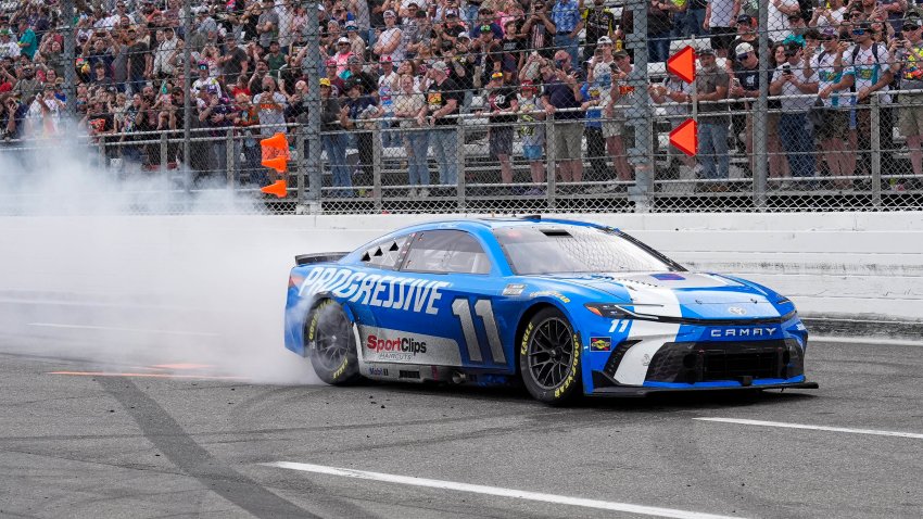 Denny Hamlin (11) does a burn out