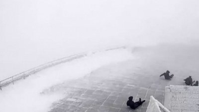 WATCH: 100 mph winds sweep scientists around mountaintop