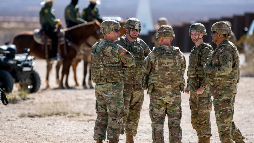 Army soldiers chat while waiting the arrival of Defense Secretary Pete Hegseth